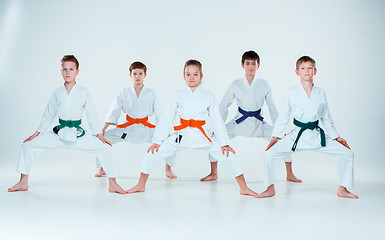 Image showing The group of boys and girl fighting at Aikido training in martial arts school. Healthy lifestyle and sports concept