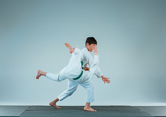 Image showing The two boys fighting at Aikido training in martial arts school. Healthy lifestyle and sports concept