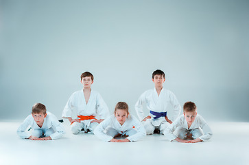 Image showing The group of boys and girl fighting at Aikido training in martial arts school. Healthy lifestyle and sports concept