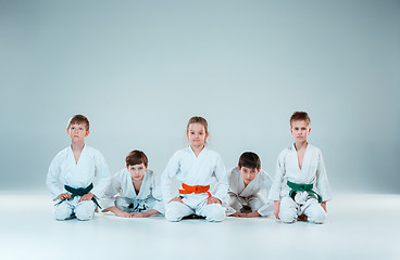 Image showing The group of boys and girl fighting at Aikido training in martial arts school. Healthy lifestyle and sports concept