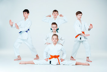 Image showing The group of boys and girl fighting at Aikido training in martial arts school. Healthy lifestyle and sports concept