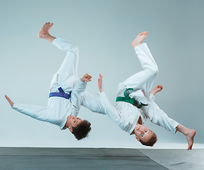 Image showing The two boys fighting at Aikido training in martial arts school. Healthy lifestyle and sports concept