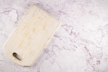 Image showing Wooden cutting board on a gray marble background