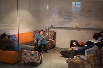 Image showing software developers sleeping on sofa in creative startup office