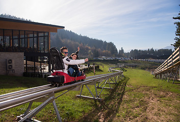 Image showing couple enjoys driving on alpine coaster