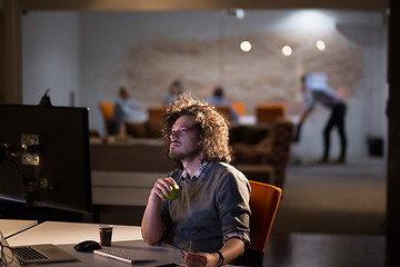 Image showing man working on computer in dark office