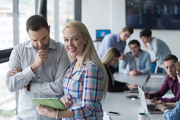 Image showing Two Business People Working With Tablet in office