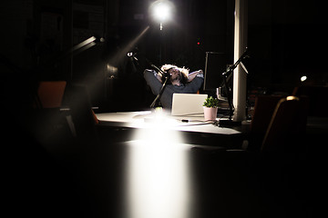 Image showing businessman relaxing at the desk