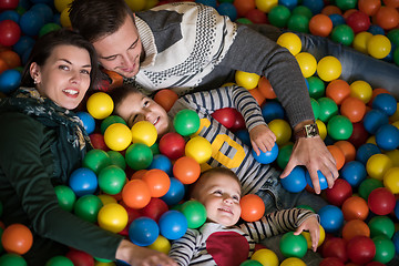 Image showing young parents with kids in a children\'s playroom