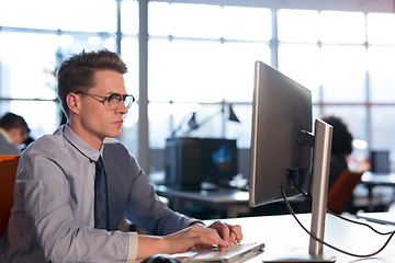 Image showing businessman working using a computer in startup office