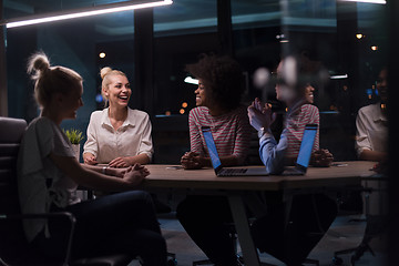 Image showing Multiethnic startup business team in night office