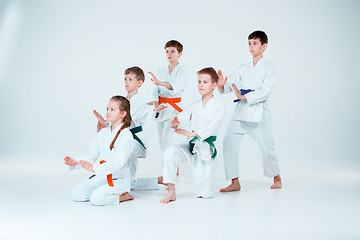 Image showing The group of boys and girl fighting at Aikido training in martial arts school. Healthy lifestyle and sports concept