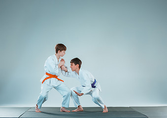 Image showing The two boys fighting at Aikido training in martial arts school. Healthy lifestyle and sports concept