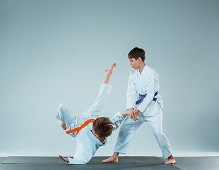 Image showing The two boys fighting at Aikido training in martial arts school. Healthy lifestyle and sports concept