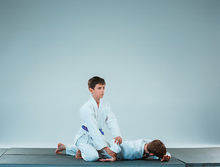 Image showing The two boys fighting at Aikido training in martial arts school. Healthy lifestyle and sports concept