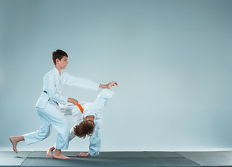 Image showing The two boys fighting at Aikido training in martial arts school. Healthy lifestyle and sports concept