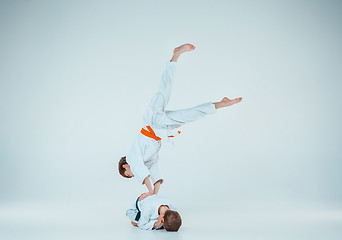 Image showing The two boys fighting at Aikido training in martial arts school. Healthy lifestyle and sports concept