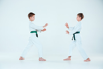 Image showing The two boys fighting at Aikido training in martial arts school. Healthy lifestyle and sports concept