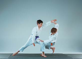 Image showing The two boys fighting at Aikido training in martial arts school. Healthy lifestyle and sports concept