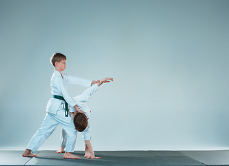 Image showing The two boys fighting at Aikido training in martial arts school. Healthy lifestyle and sports concept