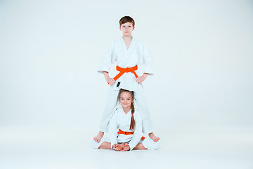 Image showing The group of boys and girl at Aikido training in martial arts school. Healthy lifestyle and sports concept