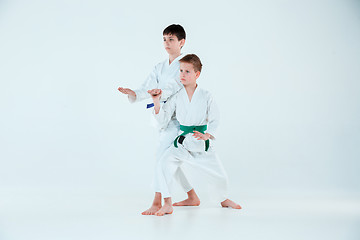 Image showing The boys posing at Aikido training in martial arts school. Healthy lifestyle and sports concept