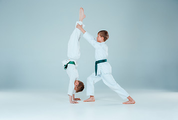 Image showing The two boys fighting at Aikido training in martial arts school. Healthy lifestyle and sports concept