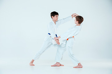 Image showing The two boys fighting at Aikido training in martial arts school. Healthy lifestyle and sports concept