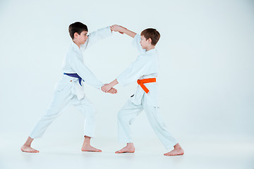 Image showing The two boys fighting at Aikido training in martial arts school. Healthy lifestyle and sports concept