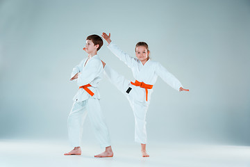 Image showing The group of boys and girl at Aikido training in martial arts school. Healthy lifestyle and sports concept