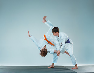 Image showing The two boys fighting at Aikido training in martial arts school. Healthy lifestyle and sports concept