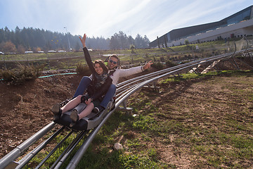 Image showing couple enjoys driving on alpine coaster