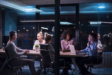 Image showing Multiethnic startup business team in night office