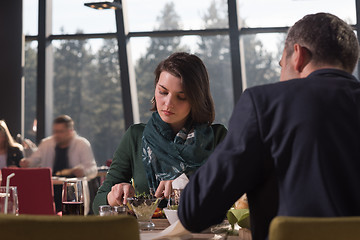 Image showing Closeup shot of young woman and man having meal.