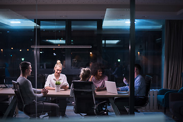 Image showing Multiethnic startup business team in night office