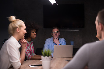 Image showing Multiethnic startup business team in night office