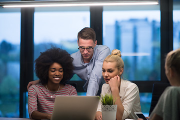 Image showing Multiethnic startup business team in night office