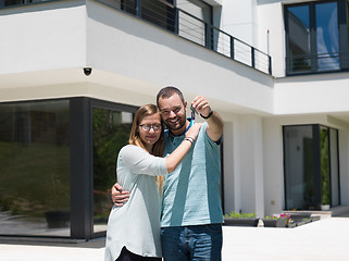 Image showing couple hugging in front of  new luxury home