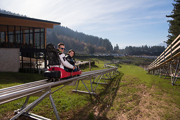 Image showing couple enjoys driving on alpine coaster