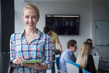 Image showing Pretty Businesswoman Using Tablet In Office Building by window