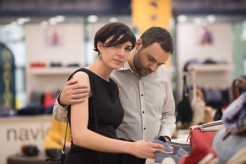 Image showing couple chooses shoes At Shoe Store