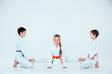 Image showing The group of boys and girl at Aikido training in martial arts school. Healthy lifestyle and sports concept