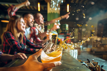 Image showing sport, people, leisure, friendship and entertainment concept - happy football fans or male friends drinking beer and celebrating victory at bar or pub