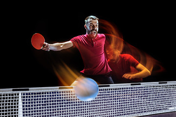 Image showing The table tennis player serving