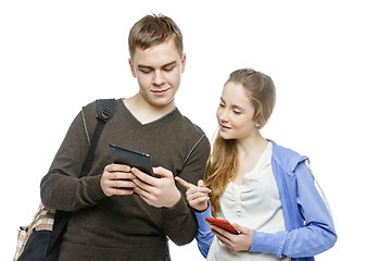 Image showing Teen boy and girl standing with mobile phones