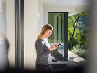 Image showing women using tablet computer in front of luxury home villa