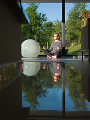 Image showing young woman doing morning yoga exercises