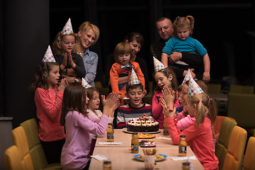 Image showing The young boy joyfully celebrating his birthday