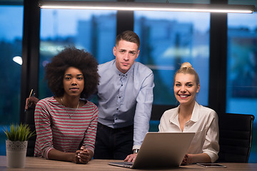 Image showing Multiethnic startup business team in night office