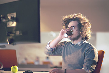 Image showing Tired businessman working late